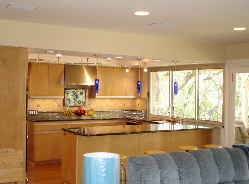 Example of a transitional u-shaped kitchen pantry design in Austin with flat-panel cabinets, light wood cabinets, beige backsplash, stainless steel appliances and no island
