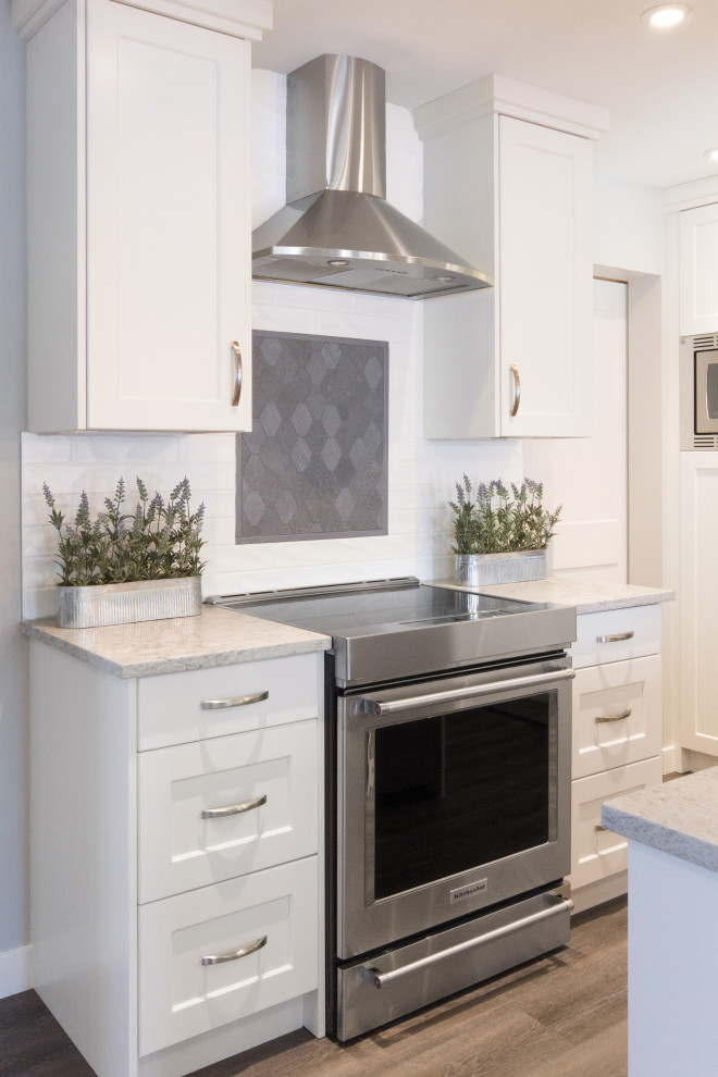 Example of a transitional kitchen design in Calgary