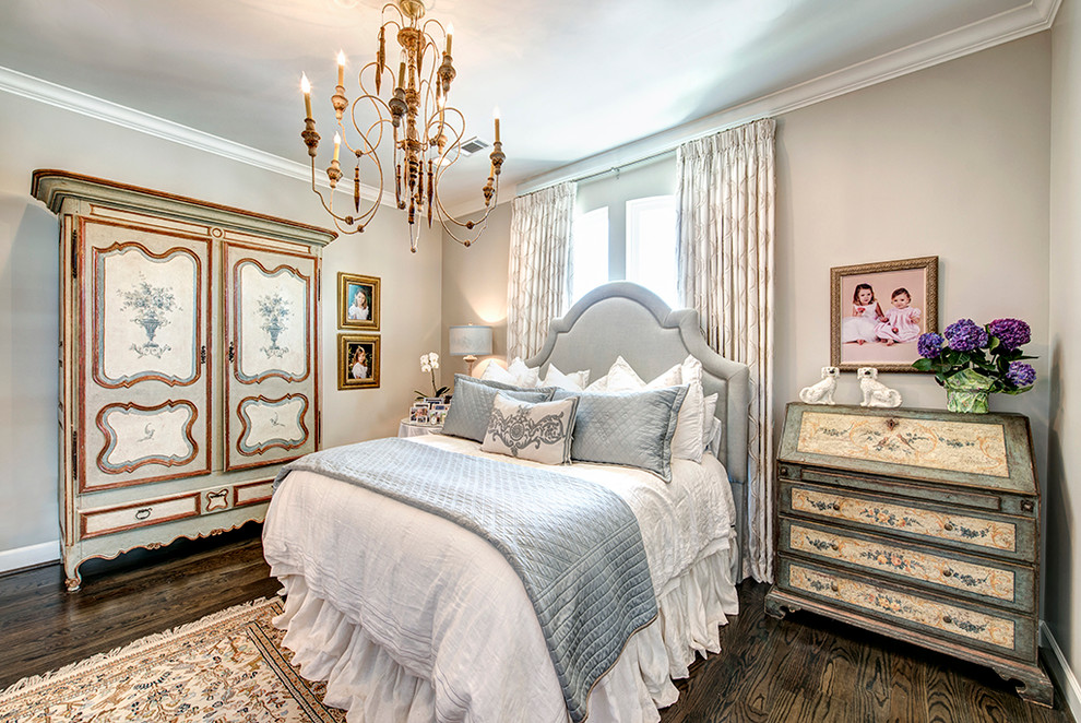 Mid-sized traditional master bedroom in Houston with grey walls and dark hardwood floors.