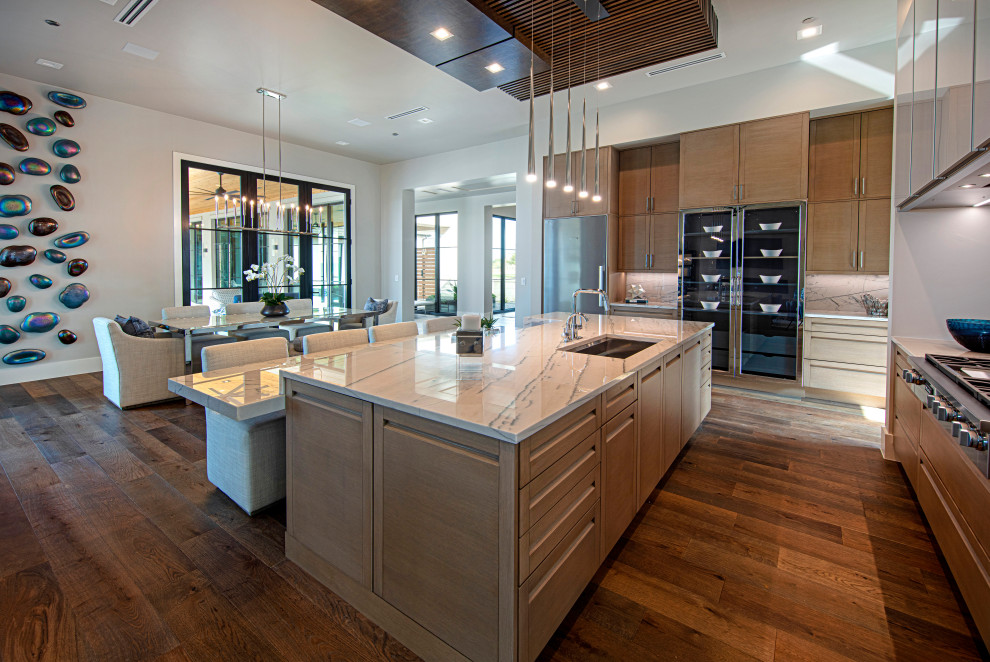 Photo of a large contemporary u-shaped eat-in kitchen in Dallas with an undermount sink, flat-panel cabinets, white cabinets, quartz benchtops, white splashback, engineered quartz splashback, stainless steel appliances, dark hardwood floors, multiple islands and white benchtop.