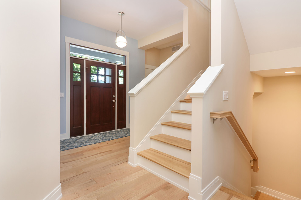 Inspiration for a traditional foyer in Grand Rapids with medium hardwood floors, a single front door and a dark wood front door.