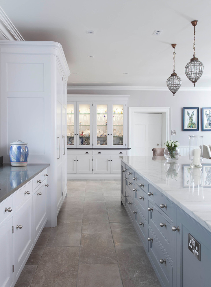Inspiration for an expansive traditional l-shaped open plan kitchen in Other with an integrated sink, shaker cabinets, grey cabinets, marble benchtops, white splashback, ceramic splashback, black appliances, ceramic floors, with island and grey floor.