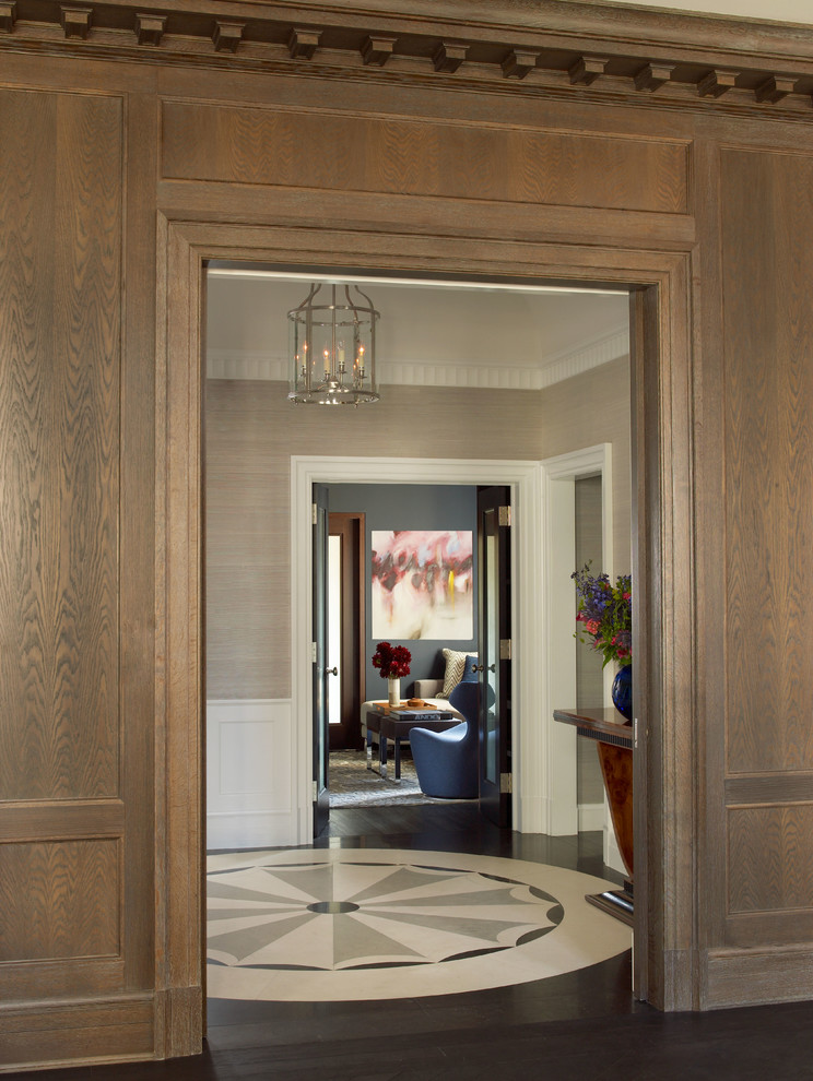 This is an example of a mid-sized transitional vestibule in New York with brown walls and granite floors.