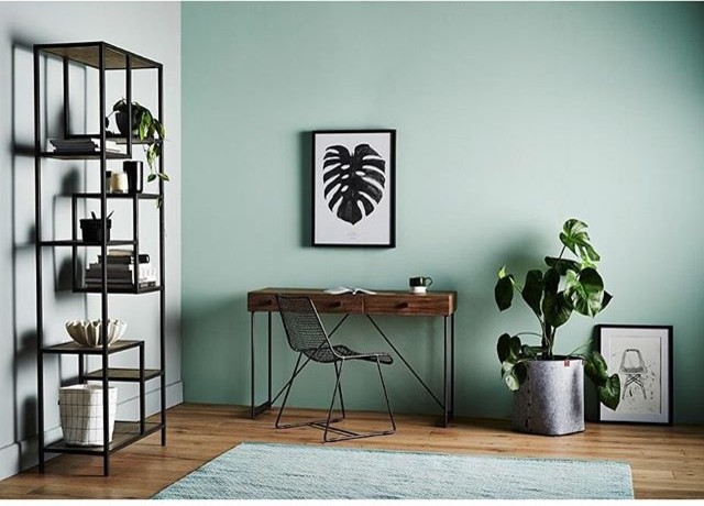 Design ideas for a mid-sized contemporary study room in Melbourne with green walls, light hardwood floors and a freestanding desk.
