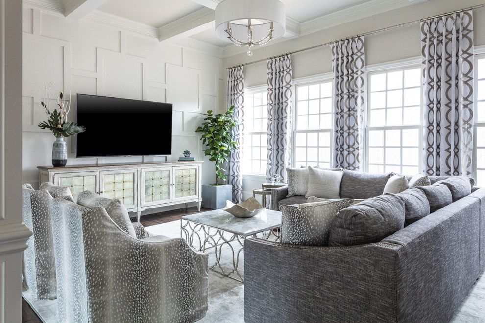 This is an example of a transitional living room in Charlotte with grey walls, dark hardwood floors, no fireplace, a wall-mounted tv and brown floor.