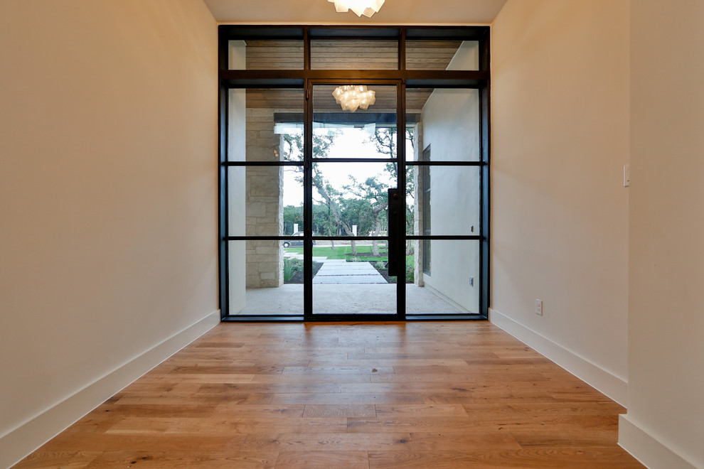 Inspiration for a modern entryway in Austin with a black front door.