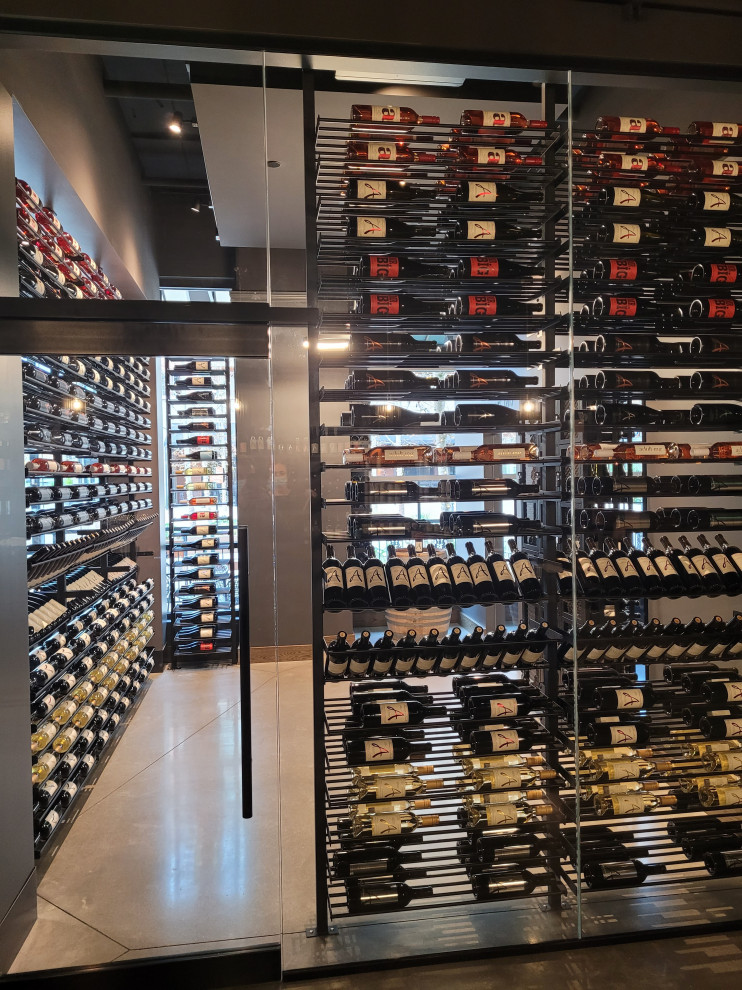 Inspiration for a large contemporary concrete floor and beige floor wine cellar remodel in Seattle with storage racks