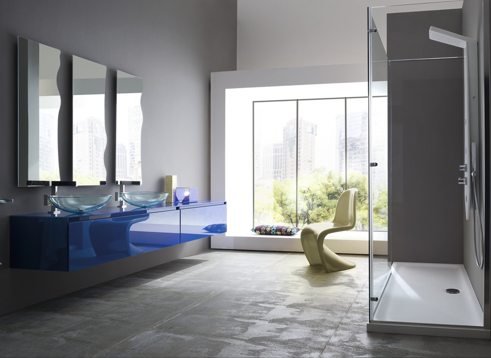 Inspiration for a small modern 3/4 bathroom in San Diego with an integrated sink, flat-panel cabinets, blue cabinets, a freestanding tub, a corner shower, a one-piece toilet, white tile, ceramic tile, grey walls and ceramic floors.