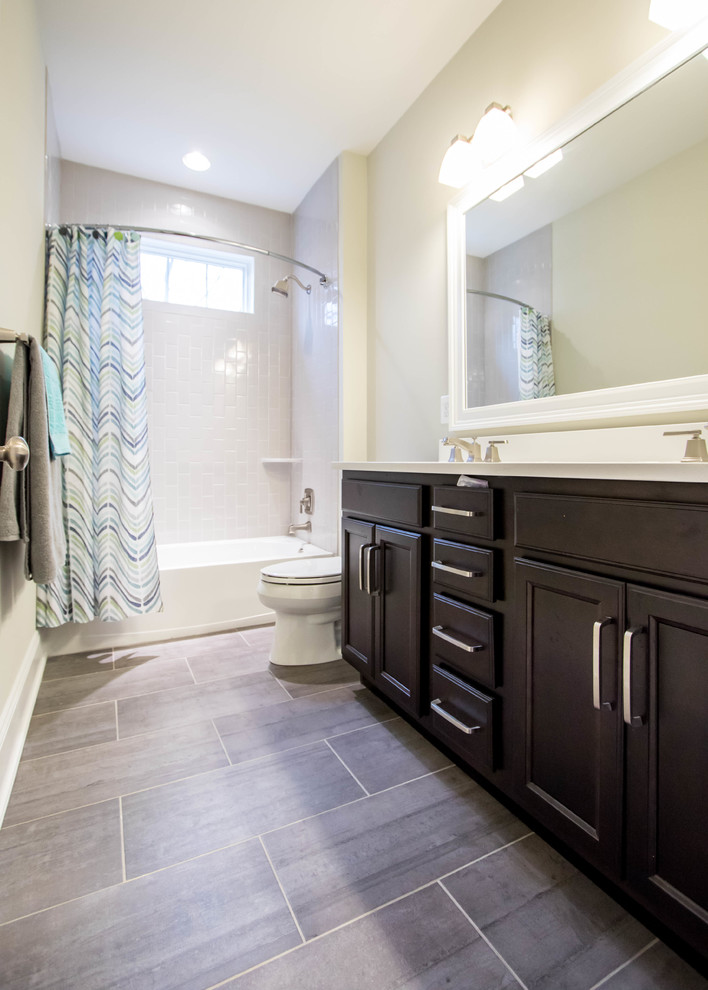Inspiration for a mid-sized transitional 3/4 bathroom in Philadelphia with recessed-panel cabinets, dark wood cabinets, an alcove tub, a shower/bathtub combo, a two-piece toilet, beige walls and an undermount sink.
