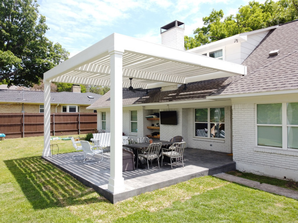 Inspiration for a large modern backyard stamped concrete patio remodel in Dallas with a pergola