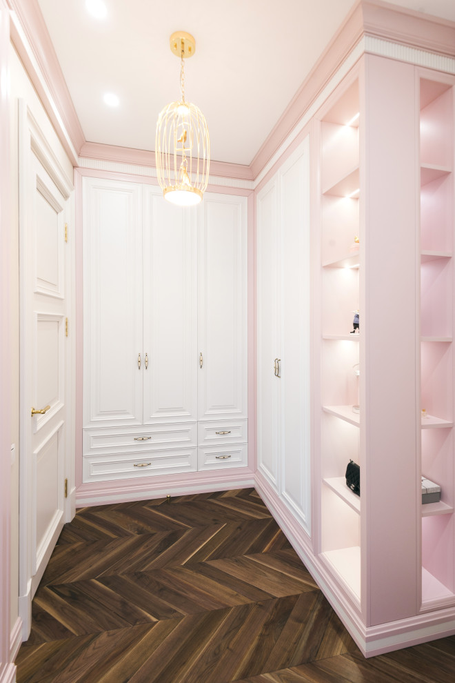 Design ideas for a large transitional women's walk-in wardrobe in Moscow with raised-panel cabinets, white cabinets, dark hardwood floors and brown floor.