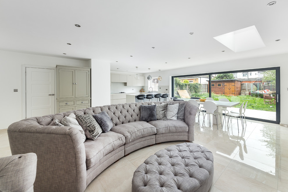 Photo of a large transitional formal open concept living room in London with porcelain floors, white walls and white floor.