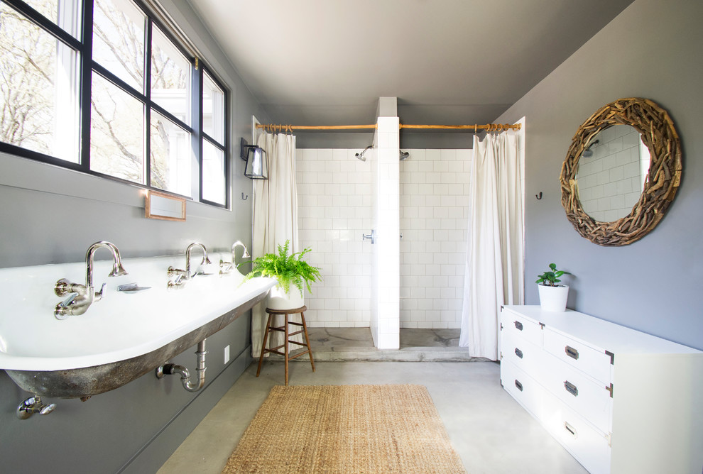 Inspiration for a mid-sized country kids bathroom in San Francisco with white tile, ceramic tile, grey walls, concrete floors, a wall-mount sink, an alcove shower, grey floor and a shower curtain.