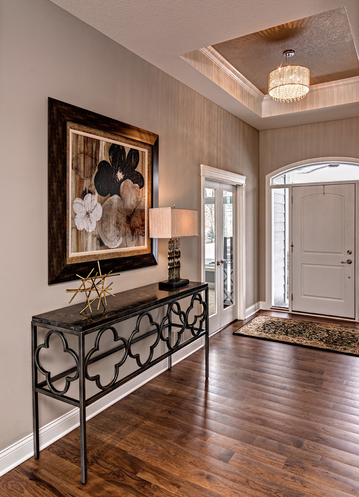 Mid-sized transitional dark wood floor and brown floor foyer photo in Minneapolis with gray walls and a white front door