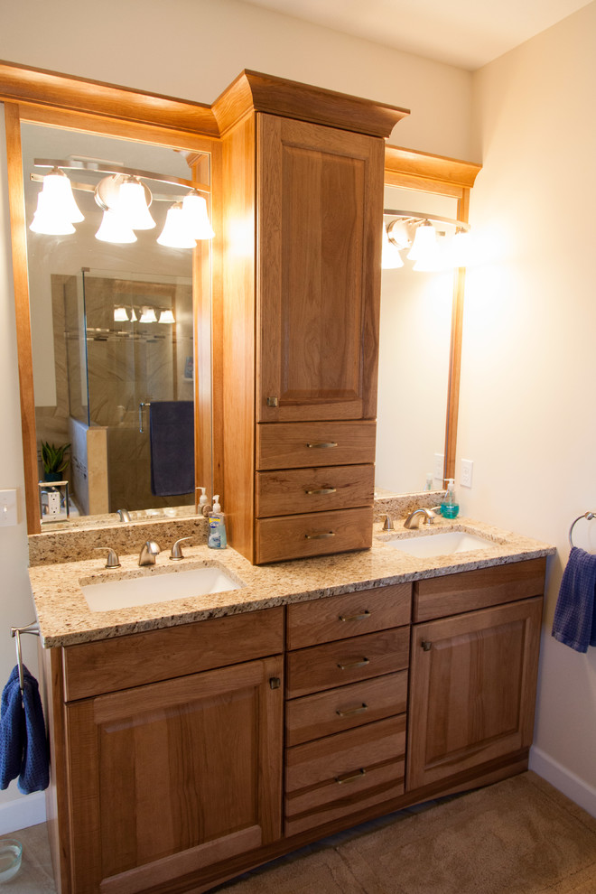 Inspiration for a mid-sized rustic master beige tile and porcelain tile porcelain tile bathroom remodel with raised-panel cabinets, light wood cabinets, beige walls, an undermount sink and quartz countertops