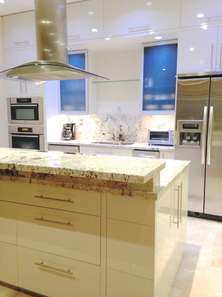 Example of a mid-sized trendy single-wall travertine floor eat-in kitchen design in Houston with an undermount sink, flat-panel cabinets, white cabinets, granite countertops, stone slab backsplash, stainless steel appliances, beige walls and an island
