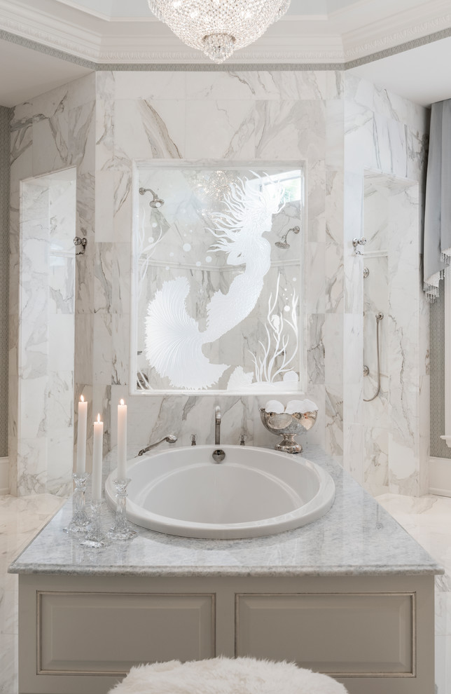Photo of a large traditional master bathroom in Miami with beaded inset cabinets, white cabinets, a drop-in tub, an open shower, white tile, marble, white walls, marble floors, an undermount sink and marble benchtops.