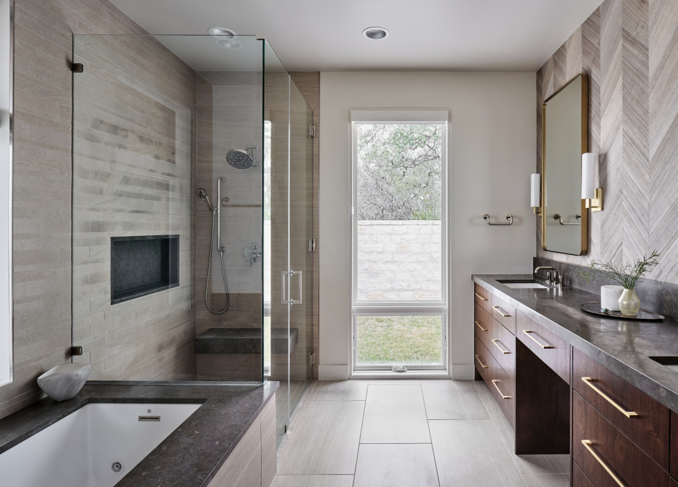 This is an example of a midcentury bathroom in Austin with flat-panel cabinets, brown cabinets, an undermount tub, a corner shower, white tile, porcelain tile, white walls, porcelain floors, an undermount sink, limestone benchtops, grey floor, a hinged shower door, grey benchtops, a double vanity, a built-in vanity and wallpaper.