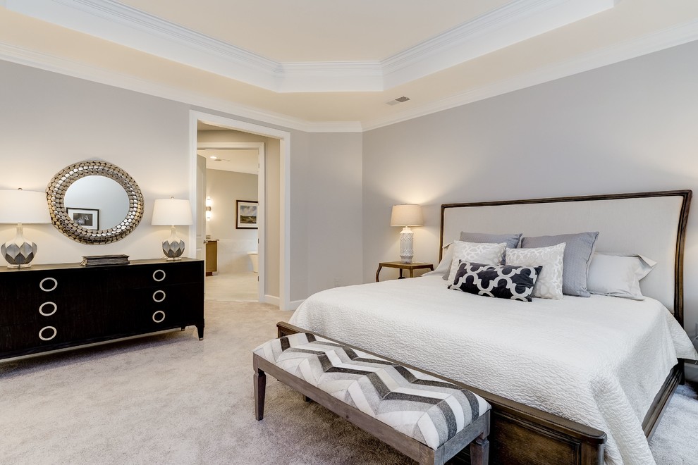 Large traditional master bedroom in DC Metro with beige walls, carpet, a standard fireplace, a tiled fireplace surround and beige floors.