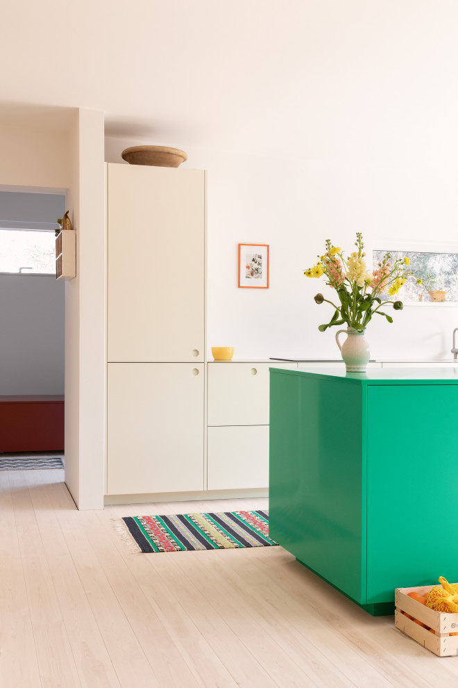 Design ideas for a medium sized scandi open plan kitchen in Copenhagen with a built-in sink, flat-panel cabinets, stainless steel worktops, an island, beige floors and grey worktops.