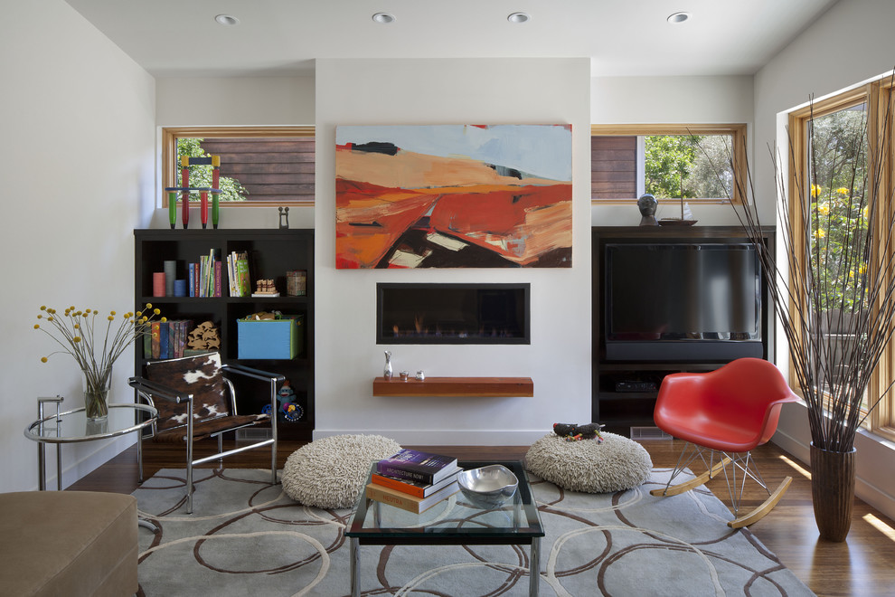 Design ideas for a modern living room in San Francisco with white walls, a library, a ribbon fireplace, a plaster fireplace surround and a built-in media wall.