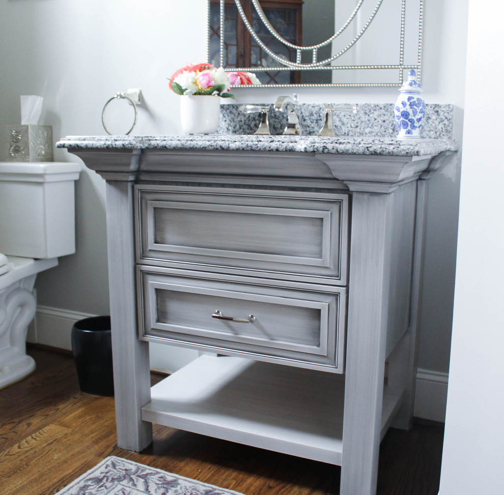 Photo of a mid-sized traditional powder room in Raleigh with furniture-like cabinets, grey cabinets, an undermount sink and granite benchtops.
