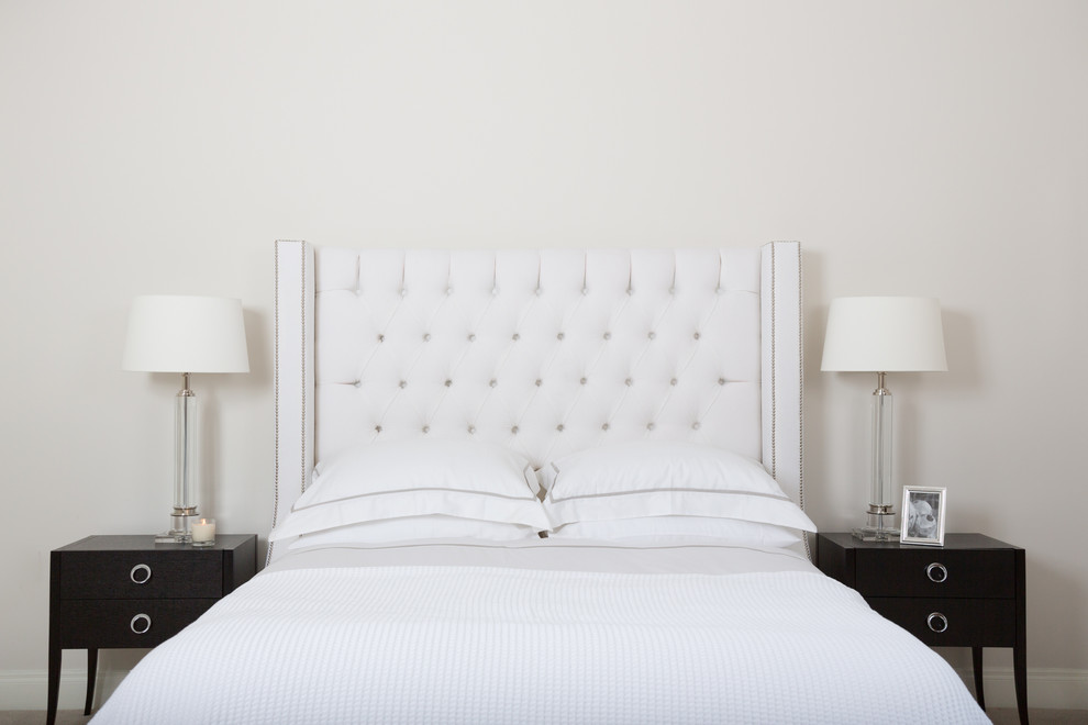 Photo of a mid-sized transitional master bedroom in Dublin with white walls.