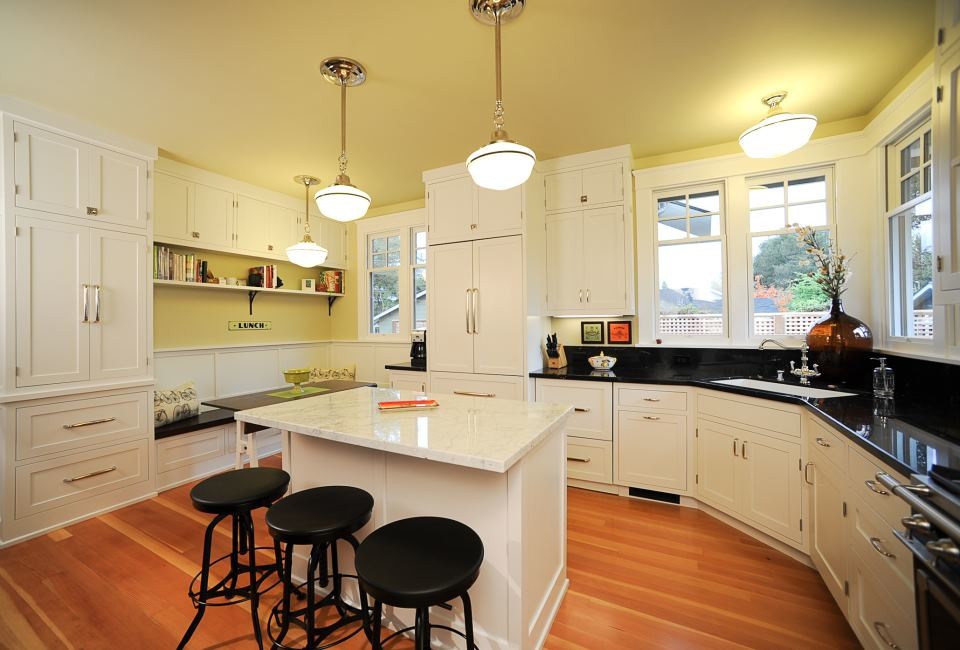 Example of a large minimalist l-shaped enclosed kitchen design in San Francisco with shaker cabinets, white cabinets, granite countertops, stainless steel appliances and an island