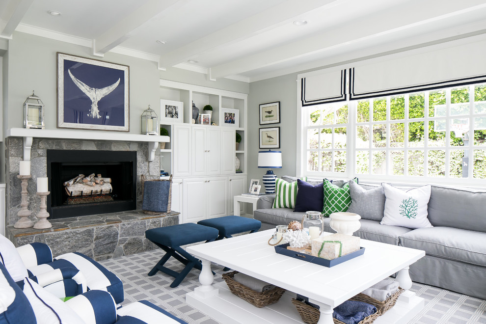 Inspiration for a beach style family room in San Diego with grey walls, a standard fireplace and carpet.
