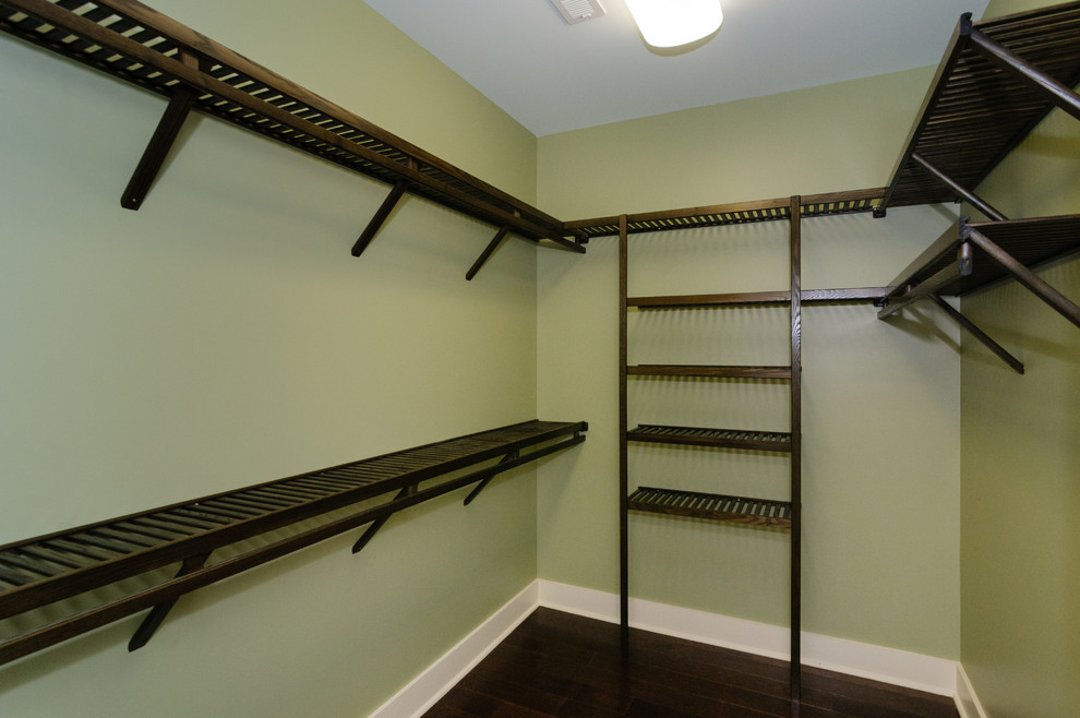 Mid-sized transitional gender-neutral dark wood floor walk-in closet photo