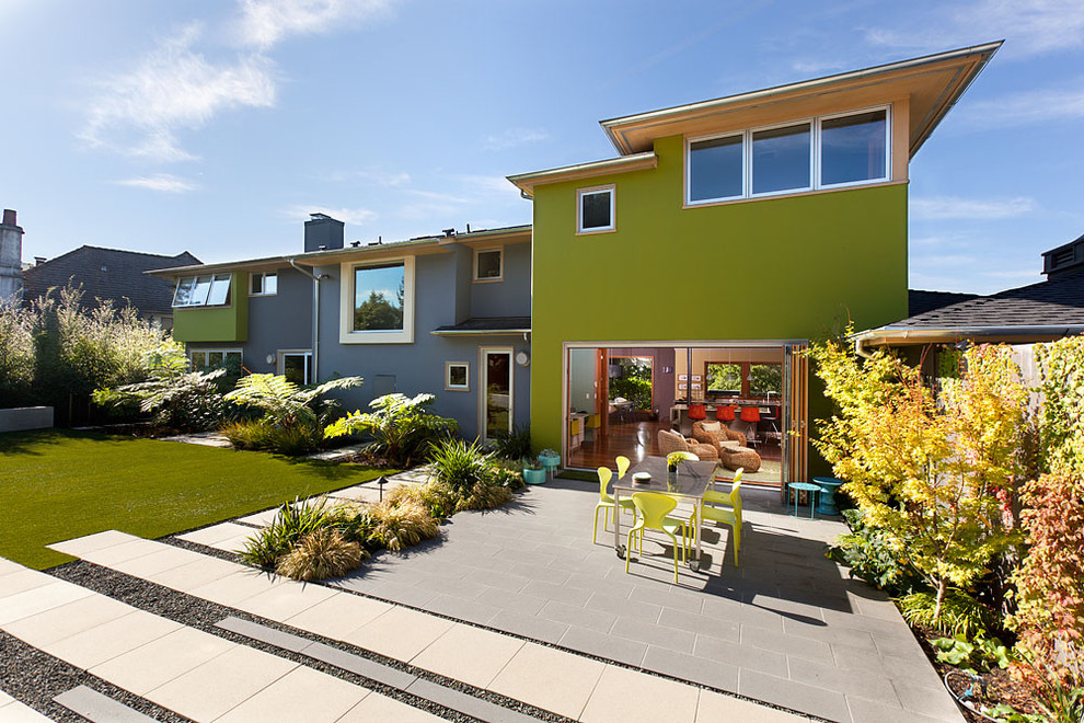 Inspiration for a large contemporary two-storey stucco green house exterior in San Francisco with a flat roof.