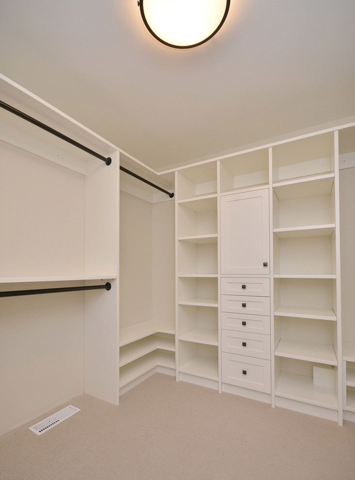 Inspiration for a mid-sized transitional gender-neutral walk-in wardrobe in Vancouver with open cabinets, white cabinets and carpet.