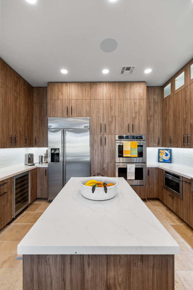 Example of a mountain style l-shaped slate floor and beige floor enclosed kitchen design with a single-bowl sink, flat-panel cabinets, medium tone wood cabinets, quartzite countertops, white backsplash, glass sheet backsplash, stainless steel appliances, a peninsula and white countertops