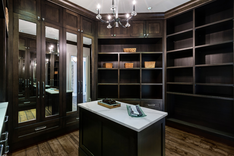 Expansive transitional men's walk-in wardrobe in Vancouver with recessed-panel cabinets, white cabinets, porcelain floors and beige floor.