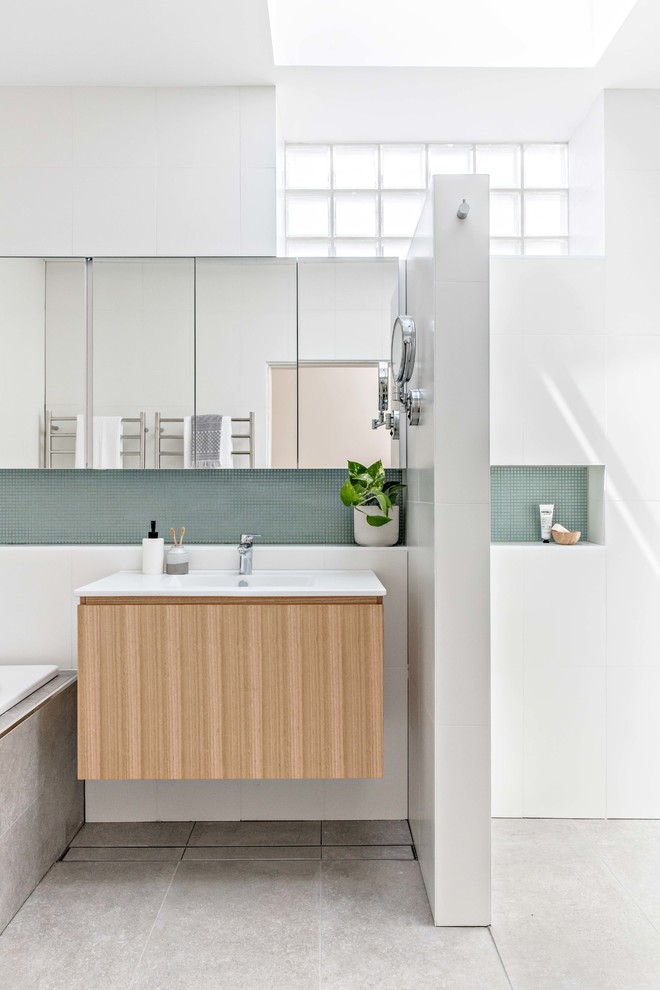 Mid-sized contemporary master bathroom in Sydney with medium wood cabinets, a drop-in tub, a corner shower, white tile, ceramic tile, white walls, porcelain floors, a wall-mount sink, grey floor and an open shower.