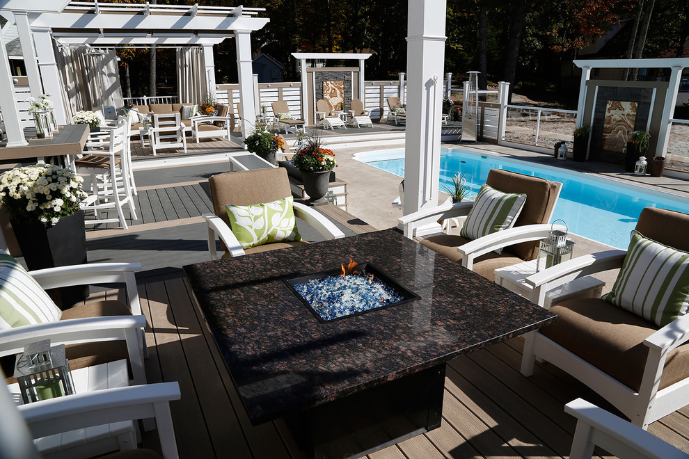 Photo of a large beach style courtyard deck in Toronto with a pergola.
