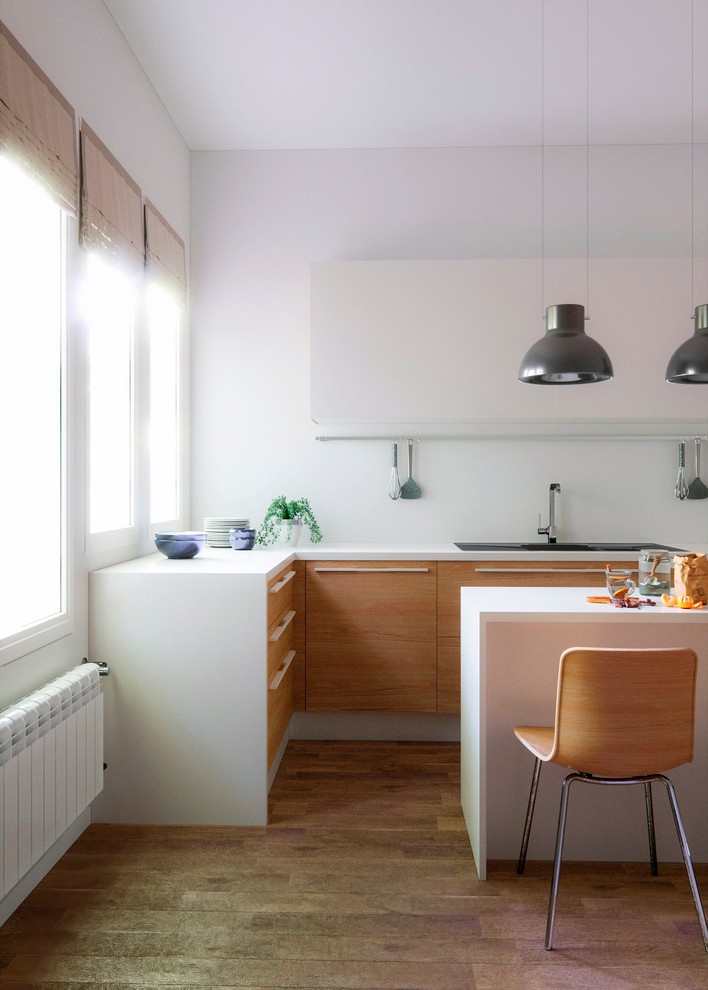 Inspiration for a mid-sized scandinavian l-shaped open plan kitchen in Palma de Mallorca with flat-panel cabinets, medium wood cabinets and white splashback.