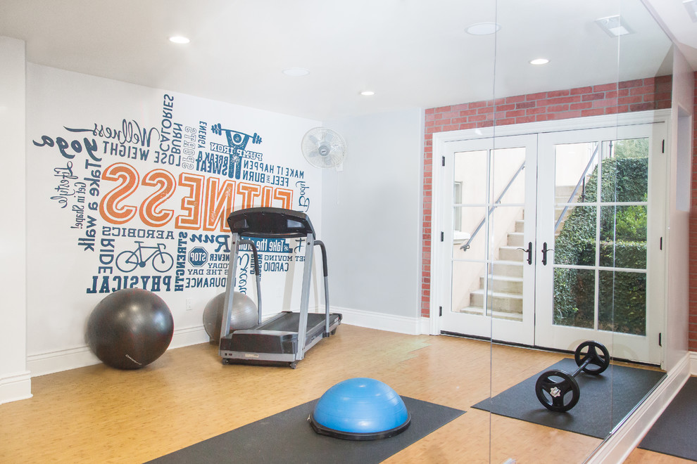 Mid-sized transitional multipurpose gym in Other with multi-coloured walls, bamboo floors and brown floor.