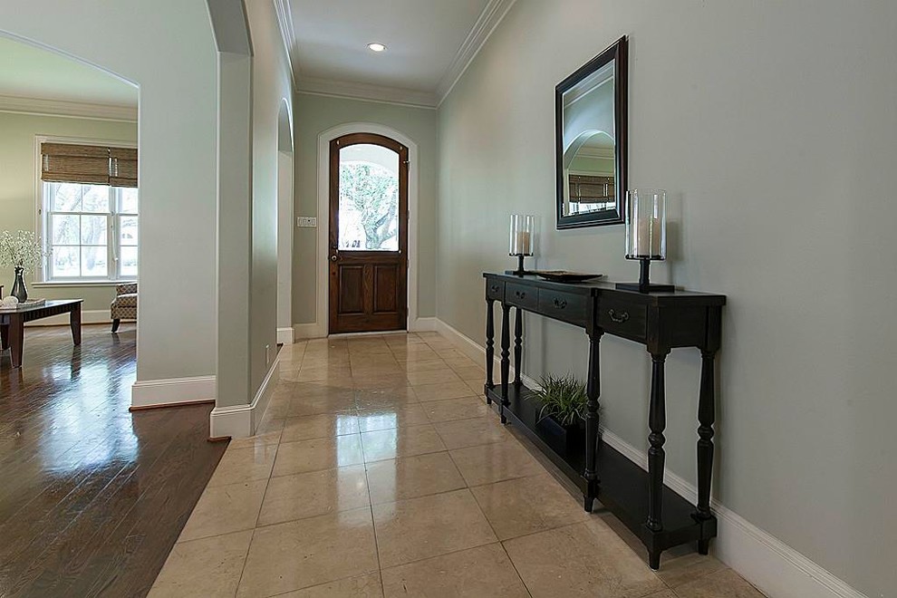 Inspiration for a transitional foyer in Houston with grey walls, travertine floors, a single front door and a medium wood front door.