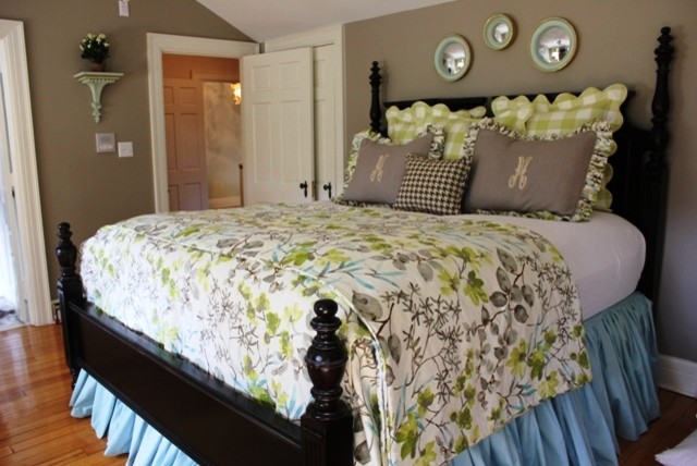 This is an example of a small transitional guest bedroom in Birmingham with grey walls and medium hardwood floors.
