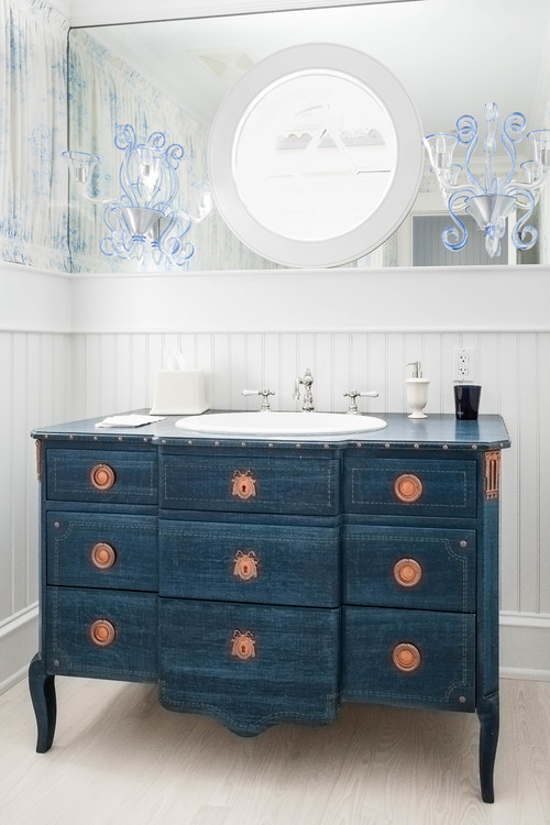 blue traditional style chest below circle mirror