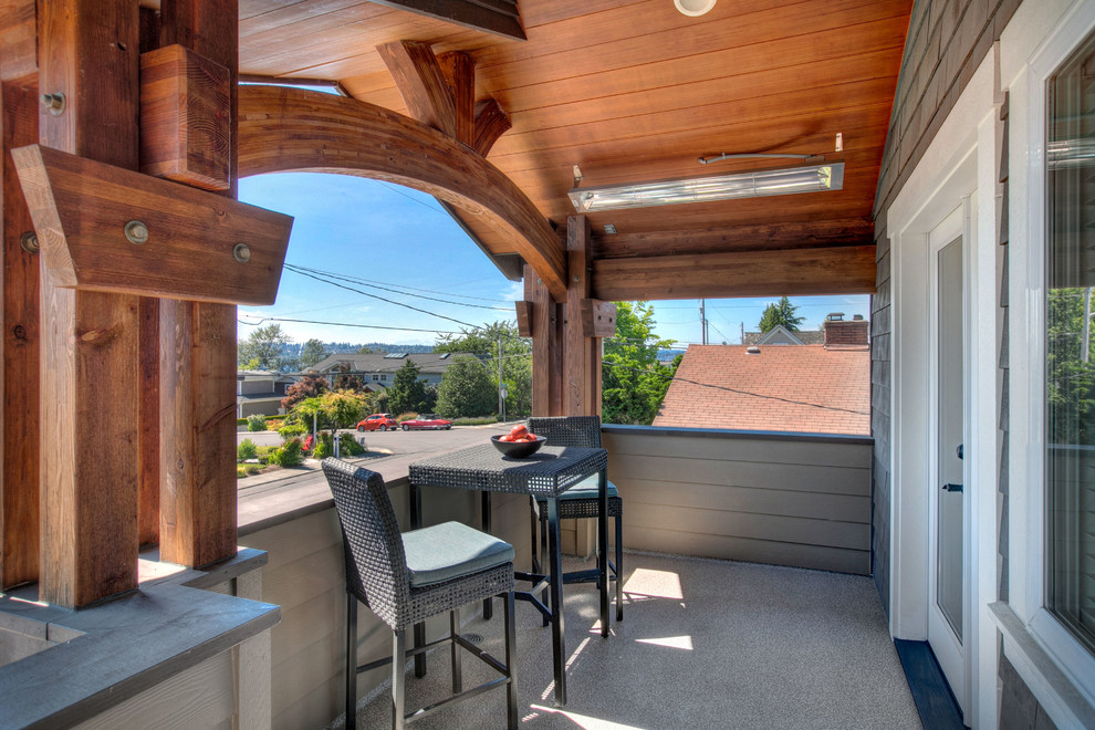 Inspiration for a mid-sized arts and crafts balcony in Seattle with a roof extension and wood railing.