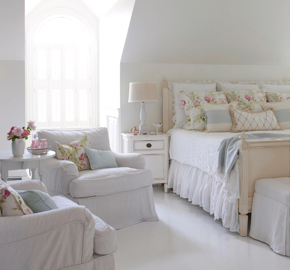 This is an example of a mid-sized beach style master bedroom in Tampa with white walls and white floor.
