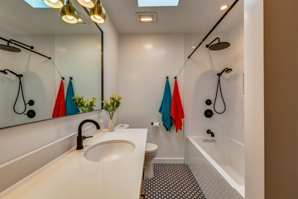 This is an example of a mid-sized contemporary kids bathroom in Los Angeles with flat-panel cabinets, medium wood cabinets, white tile, ceramic tile, porcelain floors, an undermount sink, engineered quartz benchtops, black floor, a hinged shower door, white benchtops, a single vanity and a freestanding vanity.