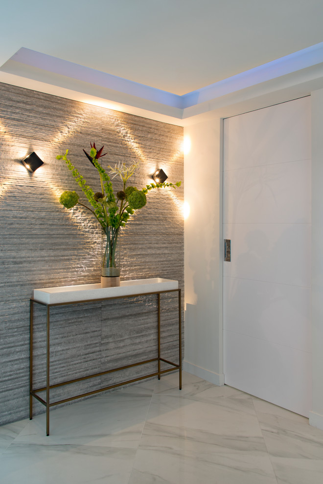 Inspiration for a mid-sized contemporary foyer in Miami with white walls, marble floors, a white front door and white floor.