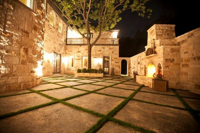 Inspiration for a large traditional courtyard patio in Dallas with a fire feature and no cover.