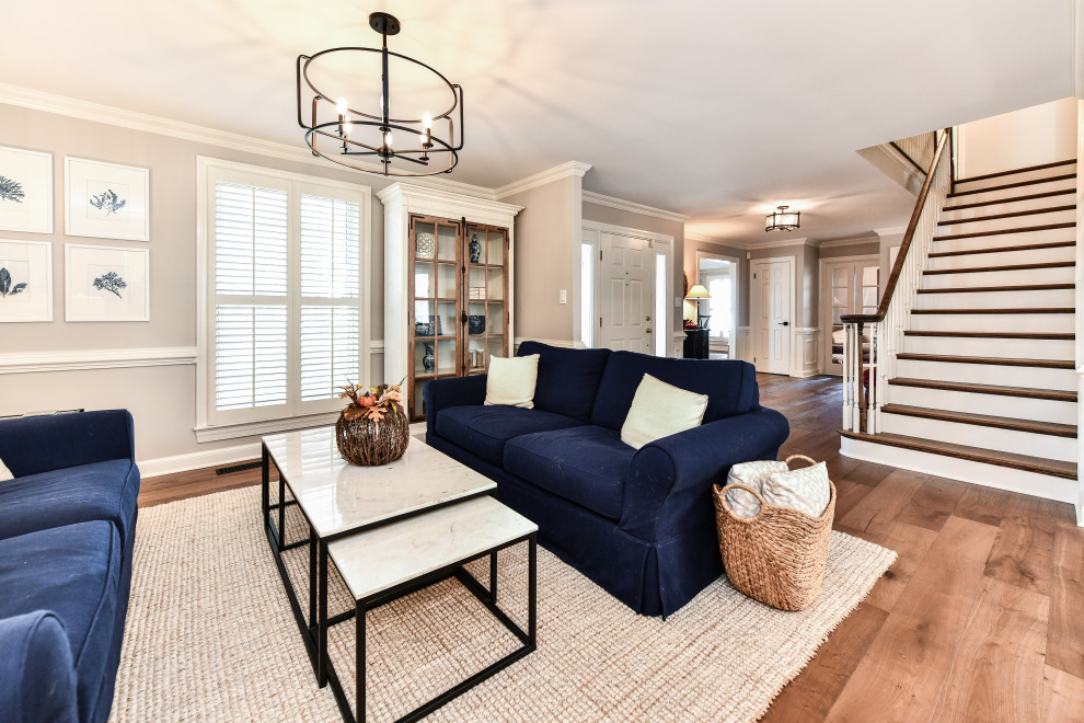 Inspiration for a mid-sized country open concept living room in DC Metro with grey walls, medium hardwood floors, no fireplace, no tv and brown floor.