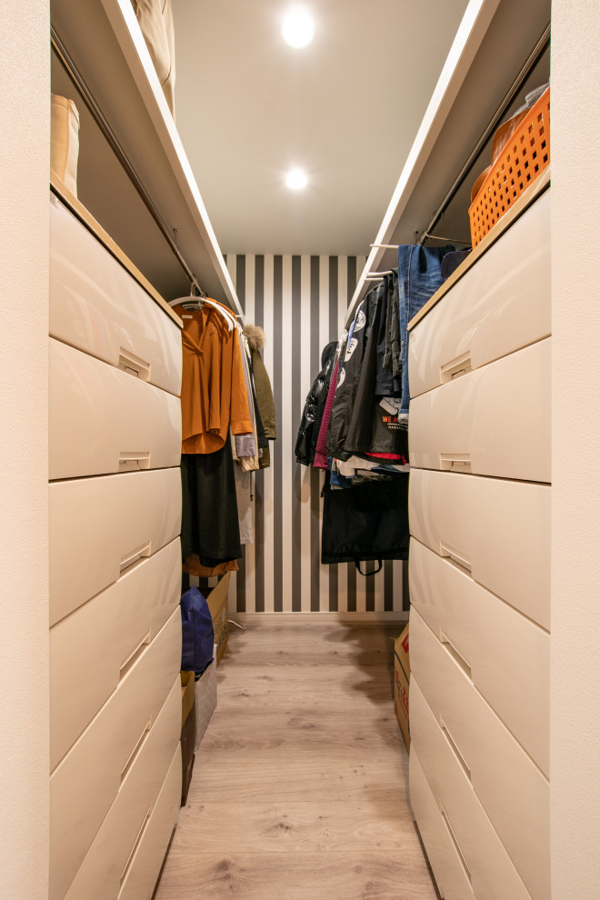 Design ideas for a small modern gender-neutral dressing room in Other with plywood floors, beige floor and wallpaper.