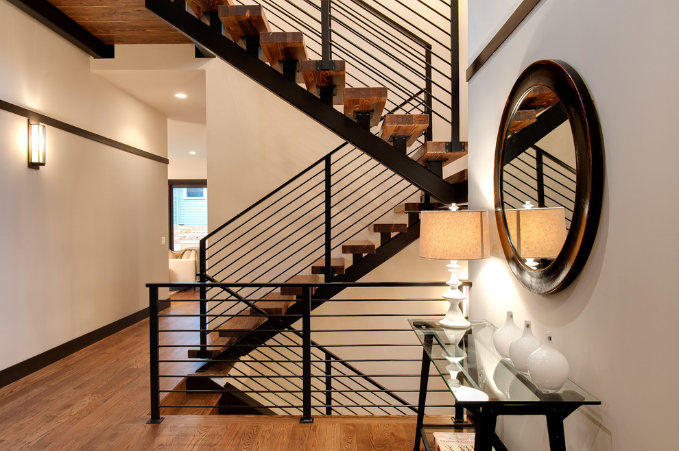 Inspiration for a contemporary wood u-shaped staircase in Seattle with open risers and metal railing.