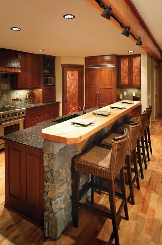 Kitchen - mid-sized rustic light wood floor kitchen idea in New York with an undermount sink, raised-panel cabinets, medium tone wood cabinets, granite countertops, multicolored backsplash, stone tile backsplash, stainless steel appliances and an island